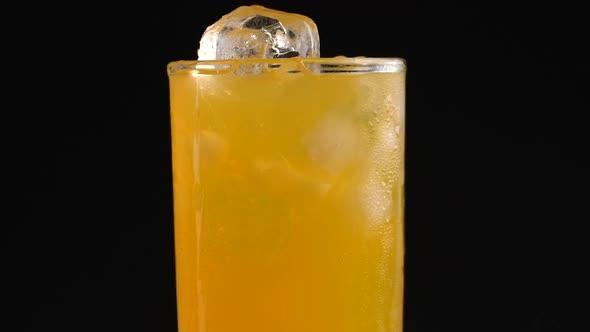 Cola with Ice and Bubbles in Glass Rotate on Black alt