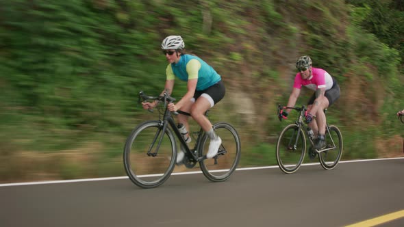 Tracking shot of a group of cyclists on country road.  Fully released for commercial use.