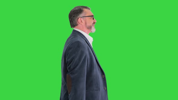 Senior Business Man Walking with Shopping Bag on a Green Screen Chroma Key alt