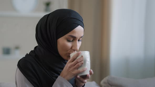 Portrait of Happy Young Muslim Woman Resting at Home Drinking Hot Tea Enjoying Weekend Smiling Girl alt