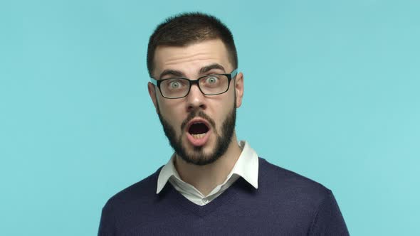 Slow Motion of Impressed Male Office Worker in Glasses Stare at Camera Raising Eyebrows Surprised