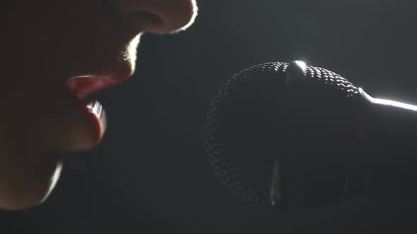 Woman singing to a microphone