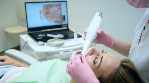 Dentist Scaning Patient's Teeth With Dental Intraoral Scanner.