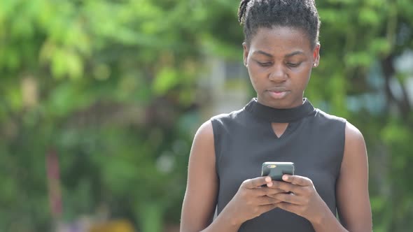 Young Beautiful African Businesswoman Using Phone Outdoors