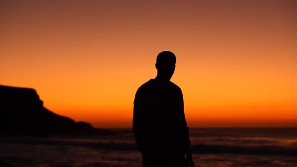 Silhouette view of a man celebrating success at seaside at sunset in Fuerteve alt