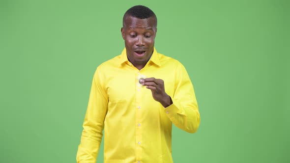 Young Happy African Businessman Playing with Fidget Spinner alt