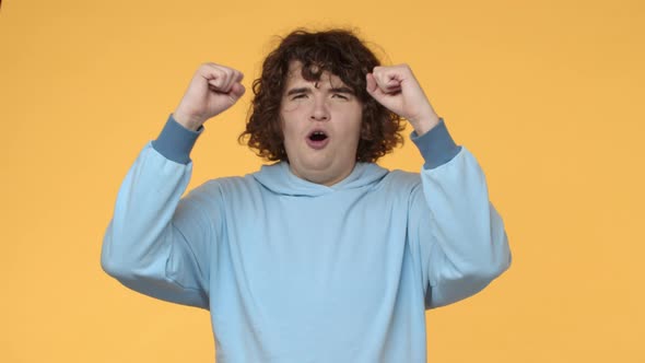 Geeky and Funny Curlyhaired Plump Teenager Male Student in Hoodie Starting Chant Rooting for Team alt