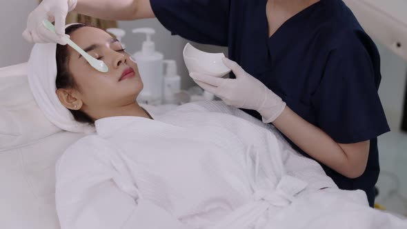 Beauty clinic concept. Young woman getting professional facial procedure. alt