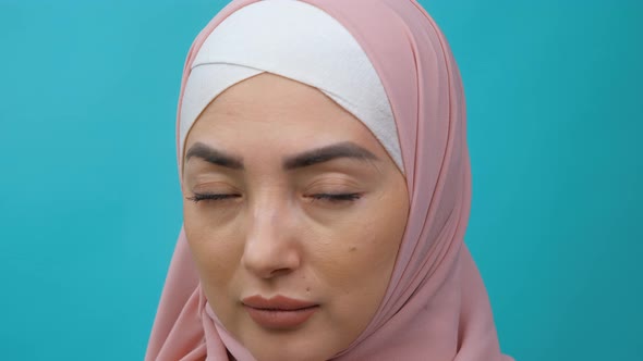 Macro of Upper Face of Young Serious Mixedrace Woman with Hijab Looking at Camera