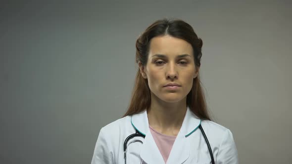 Young Lady Doctor Showing Red Ribbon Sign on Hand, AIDS Awareness Campaign alt