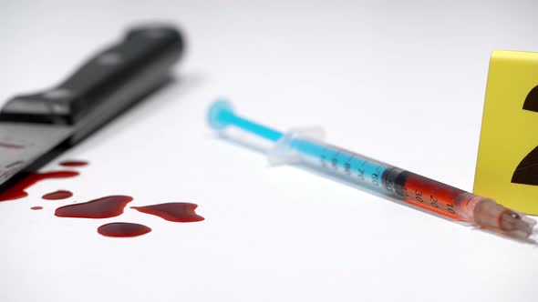 Syringe on a Crime Scene with Drugs and a Knife in the Blood alt