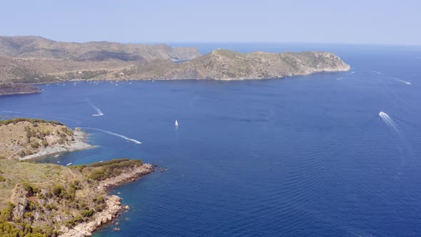 Aerial of Mountains and Sea with Yachts Near Mediterranean Town of Roses Spain alt