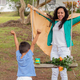 Superhero Playtime: Mother and Son Having Fun with a Cape in the Backyard - PhotoDune Item for Sale