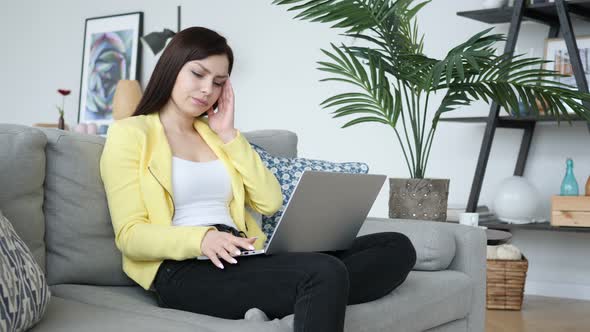 Headache, Woman Working while Sitting on Sofa in Casual Place alt