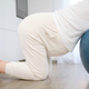 Pregnant woman resting on fitball during contractions at home - PhotoDune Item for Sale