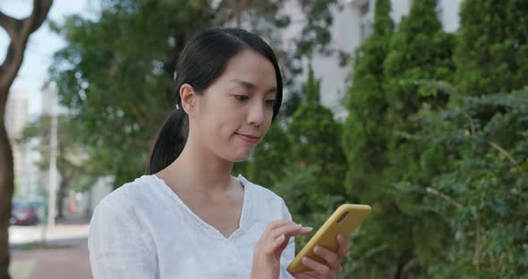 Woman check on mobile phone at outdoor 