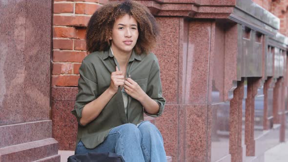 Distressed Confused Young AfroAmerican Woman Siting on Stairs Outdoors Feel Chills Alone alt