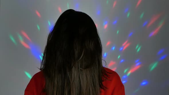 A Pretty Young Woman Dressed As Santa Claus Smiles and Waves Her Hand in Greeting