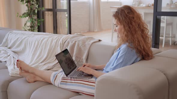 Lady Using Computer in the Living Room