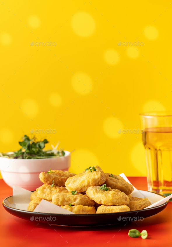 Fast food chicken nuggets paired with a glass of apple juice Stock Photo by photopopova
