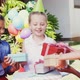 Smiling girl receiving gifts from friends 4k
