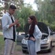 Side View Couple Talking Standing in Subsurb at Broken Automobile with Open Car Hood - VideoHive Item for Sale