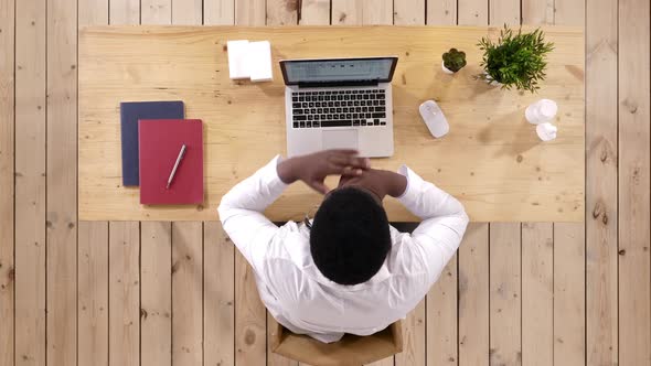 African American Doctor Working at Computer and Laptop Reading Something alt