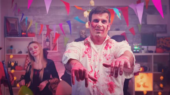 Zoom in Shot of Spooky Zombie at a Halloween Party alt