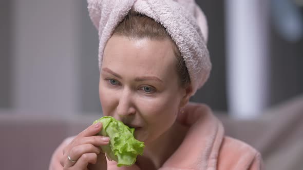 Tired Dissatisfied Young Woman in Hair Towel Eating Green Salad Leaf Sighing alt