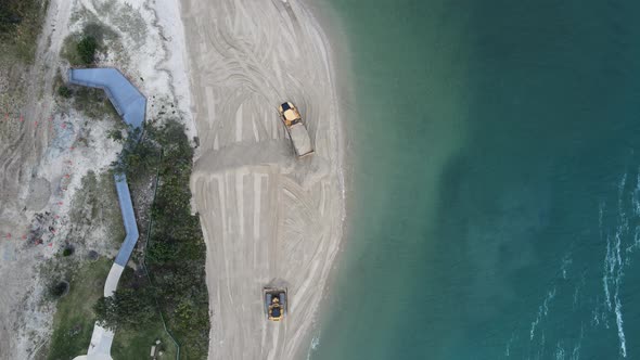 Unique view of large machinery working on a environmentally sensitive coastal rejuvenation project. alt