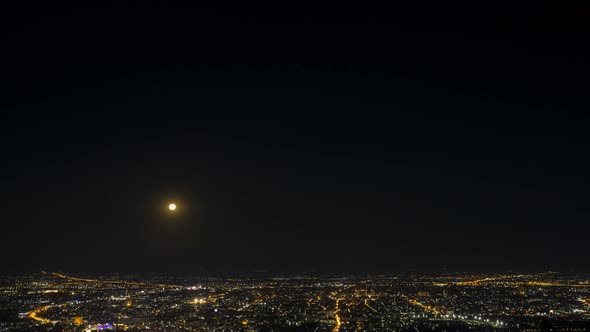 Time lapse of Chiang mai city night, Thailand with moon raise from the view point alt