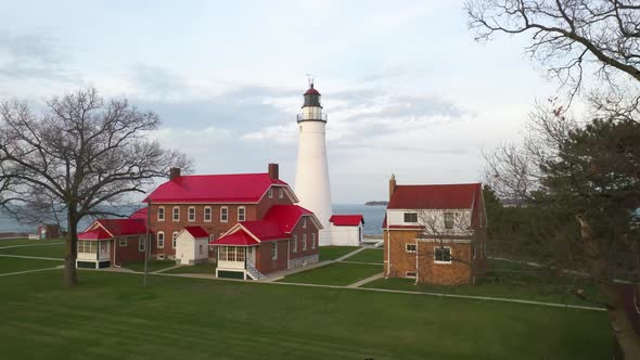 Fort Gratiot Lighthouse in Port Huron, Michigan with drone videoing forward from low ground. alt
