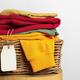 Colorful Folded Clothes in a Wicker Basket - PhotoDune Item for Sale