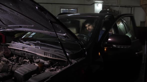 Auto Mechanic Trying To Start Car During Repairing alt