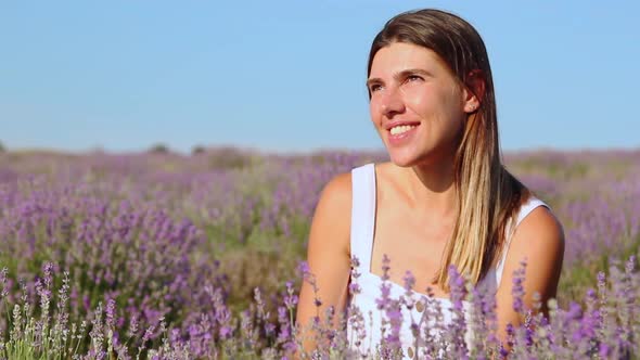 Happy Woman Sitting in Lavender Field Summertime