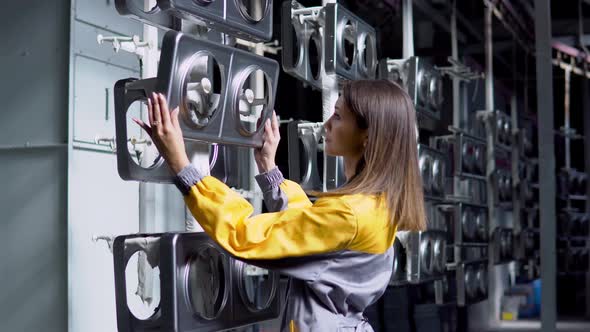 A Young Pretty White Woman Works in the Paint Shop of the Plant She Checks the Unpainted Metall alt