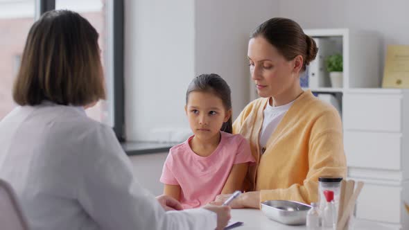 Mother with Little Daughter and Doctor at Clinic alt