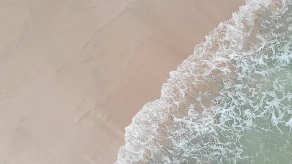 Top view of waves hitting the shore