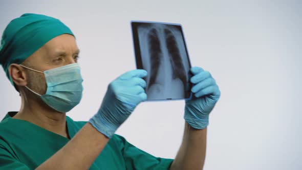 Male Pulmonologist Checking Patients Lungs Scan, Happy With Recovery Results alt
