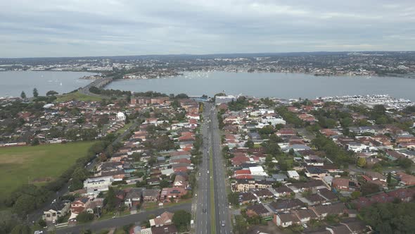 4K aerial dual carriageway or divided highway at the center among the neighborhood homes, houses and alt