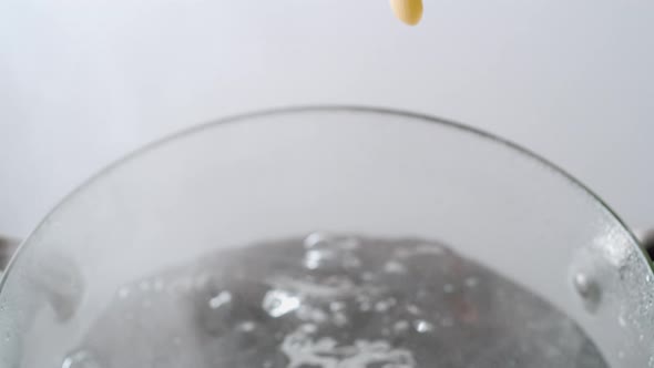 Camera follows cooking macaroni pasta in boiling water. Slow Motion. alt