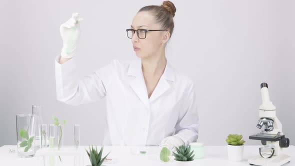 Pretty Female Scientist Works in Lab Plantbased Active Ingredients Research