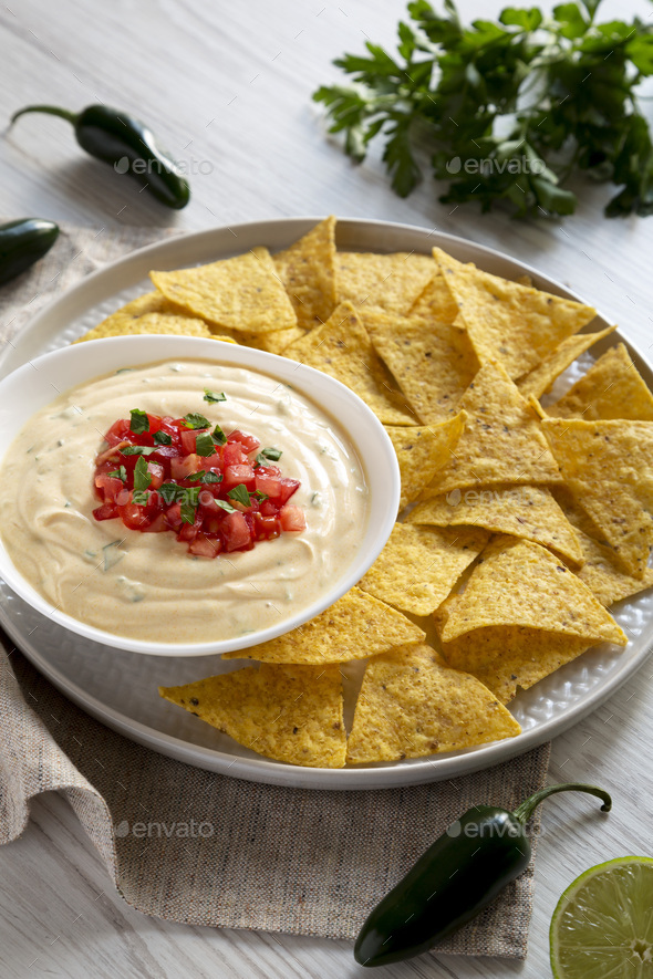 Homemade Cheesy Dip In A Bowl, Yellow Tortilla Chips Over White Wooden ...