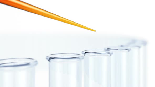 Endless drops of orange liquid falling into test tubes in the laboratory. HD alt