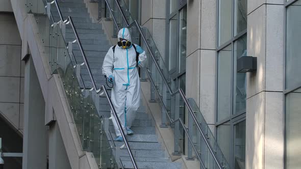 Cleaning City Streets with a Pressure Washer. A Janitor Disinfects Steps and Handrails in a Public alt