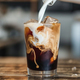 Pouring cream into iced coffee creates a swirl of flavor - PhotoDune Item for Sale