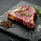 Prime ribeye steak seasoned with herbs on a slate - PhotoDune Item for Sale