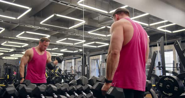 Fitness Man Pumping Up Arm Muscles. Fitness Workout And Bodybuilding. alt