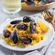 Seafood paella with mussels and shrimps, on white plate, with lemon and white wine, square - PhotoDune Item for Sale