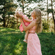 Portrait of a mother holds, throws up and spins the daughter on hands on nature on summer day vacati - PhotoDune Item for Sale
